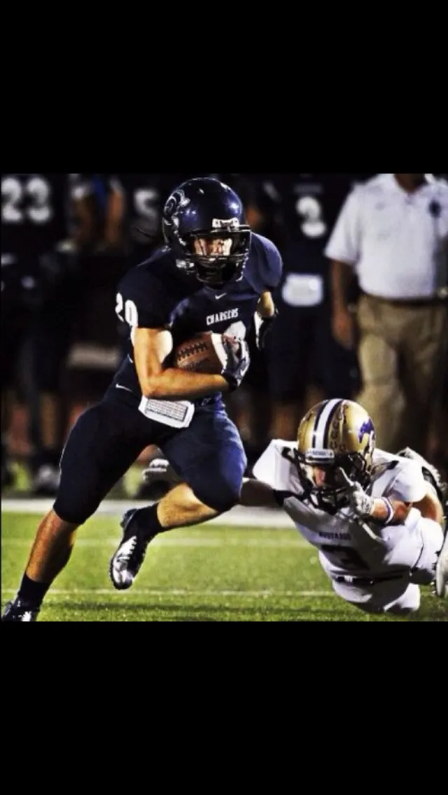 Austin Humphrey as Chargers #20, running with the football under Friday night lights